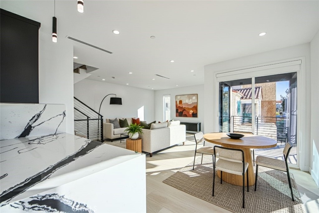 2202 Thurman Avenue Los Angeles, CA 90016 - Photo 2 of 25 a room with a table chairs and a wooden floor