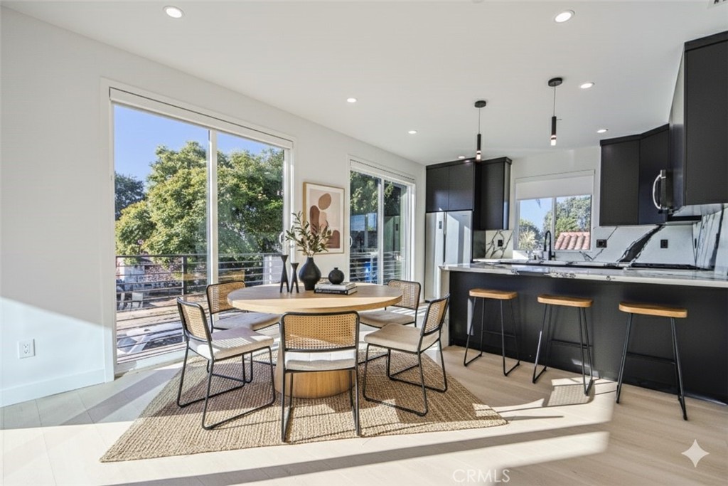 2202 Thurman Avenue Los Angeles, CA 90016 - Photo 5 of 25 a dining hall with stainless steel appliances kitchen island granite countertop a sink and cabinets