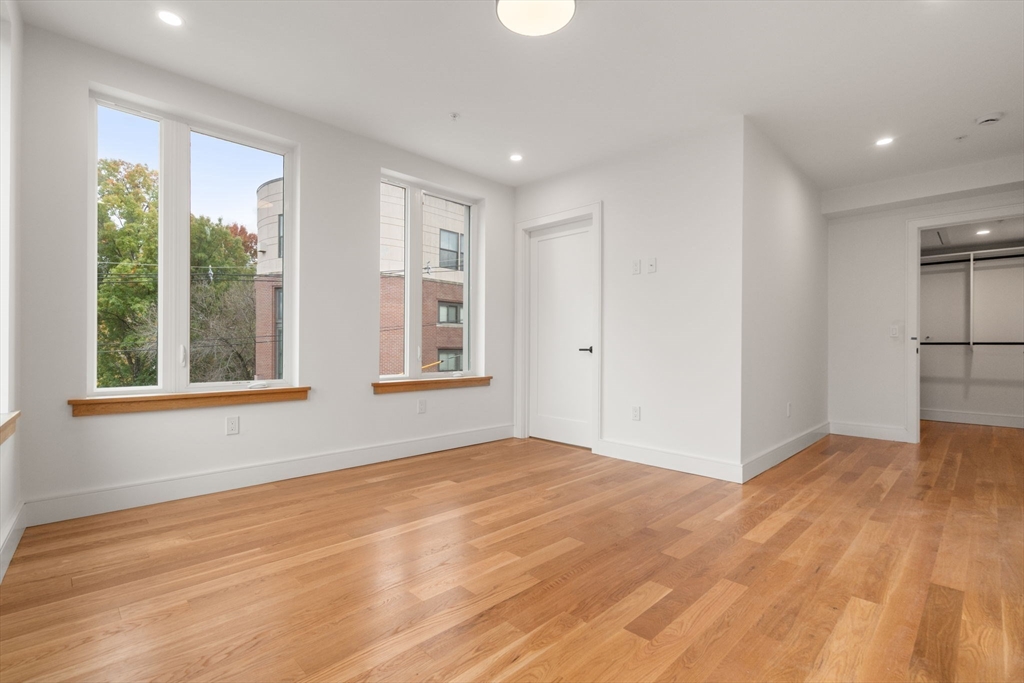 58 Kent, Unit 301 Brookline, MA 02445 - Photo 17 of 24 a view of empty room with wooden floor and fan