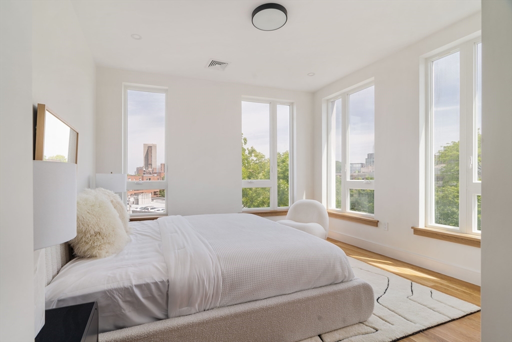 58 Kent, Unit 301 Brookline, MA 02445 - Photo 10 of 24 a bedroom with a large bed and a window