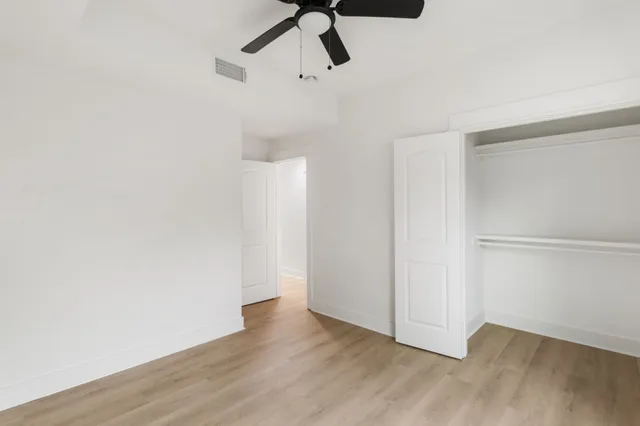 a view of a room with wooden floor