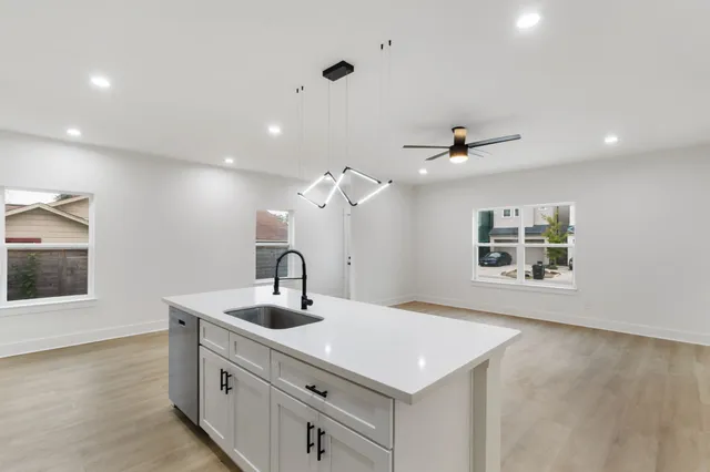 a kitchen with a sink and a refrigerator