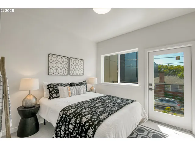 a bedroom with a bed and a large window