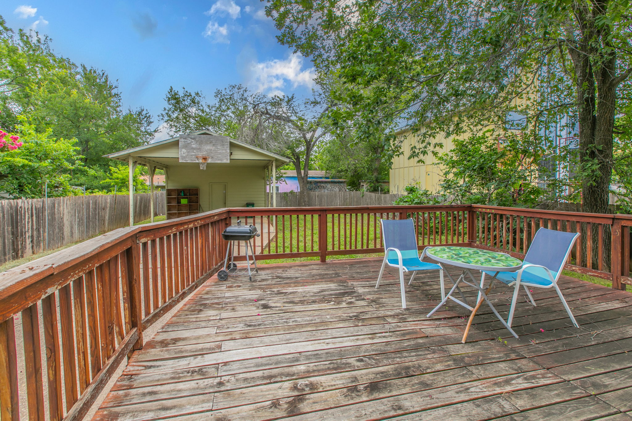 1107 Vargas Road Austin, TX 78741 - Photo 12 of 17 A spacious wooden deck provides an inviting outdoor entertaining area, perfect for relaxed gatherings.