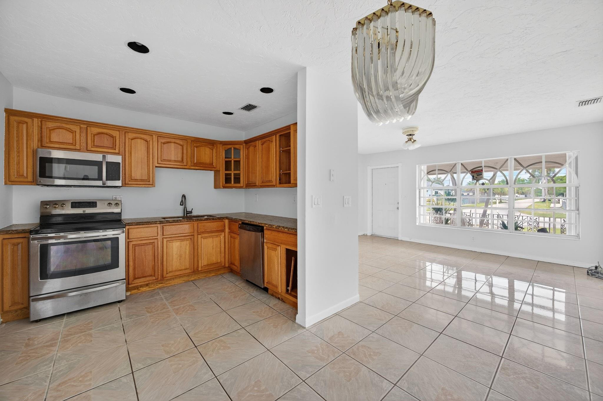 11720 Southwest 176th Street Miami, FL 33177 - Photo 16 of 31 a kitchen with stainless steel appliances granite countertop a stove and a sink