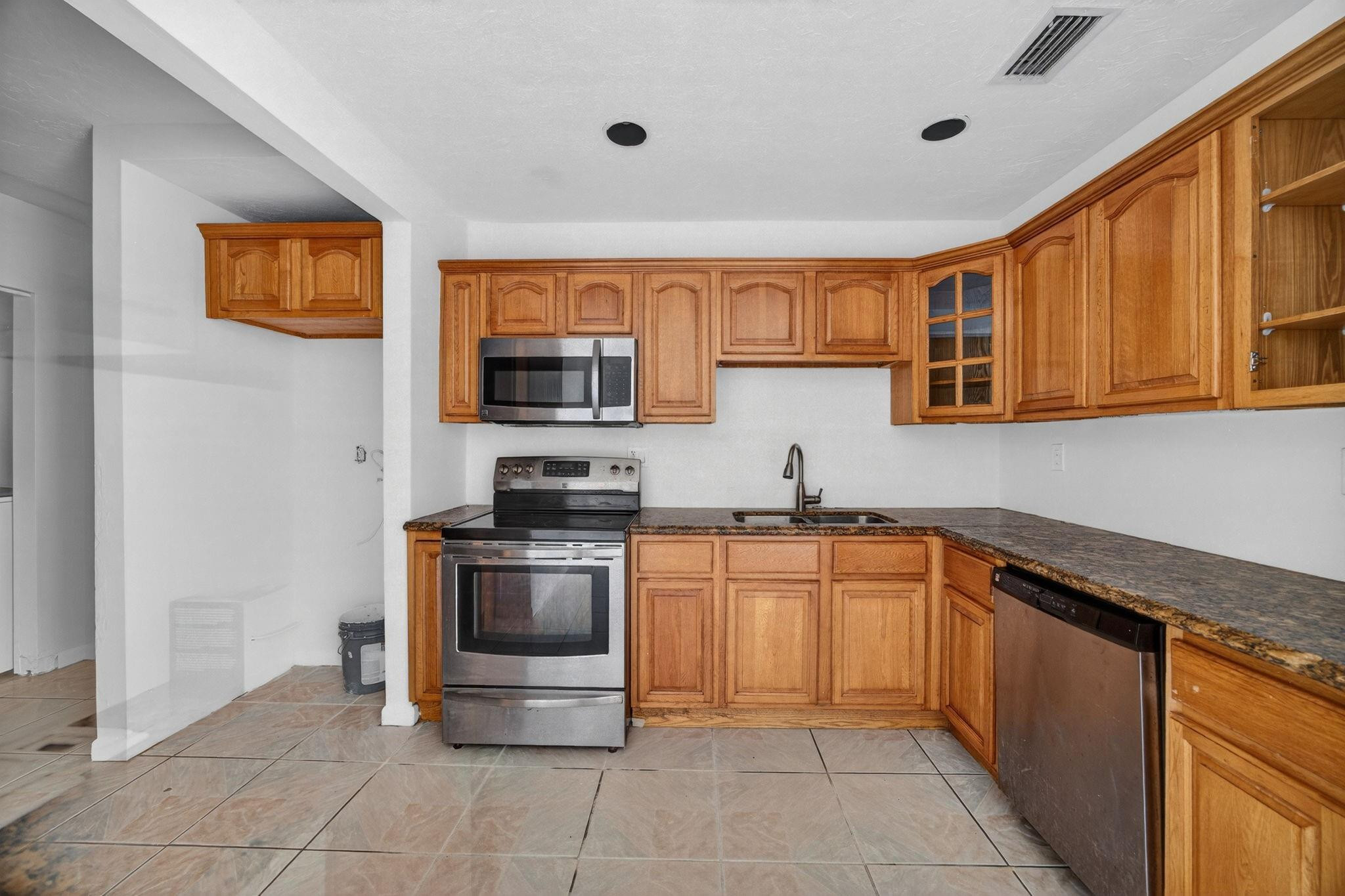 11720 Southwest 176th Street Miami, FL 33177 - Photo 17 of 31 a kitchen with stainless steel appliances granite countertop a stove top oven a sink dishwasher and a refrigerator