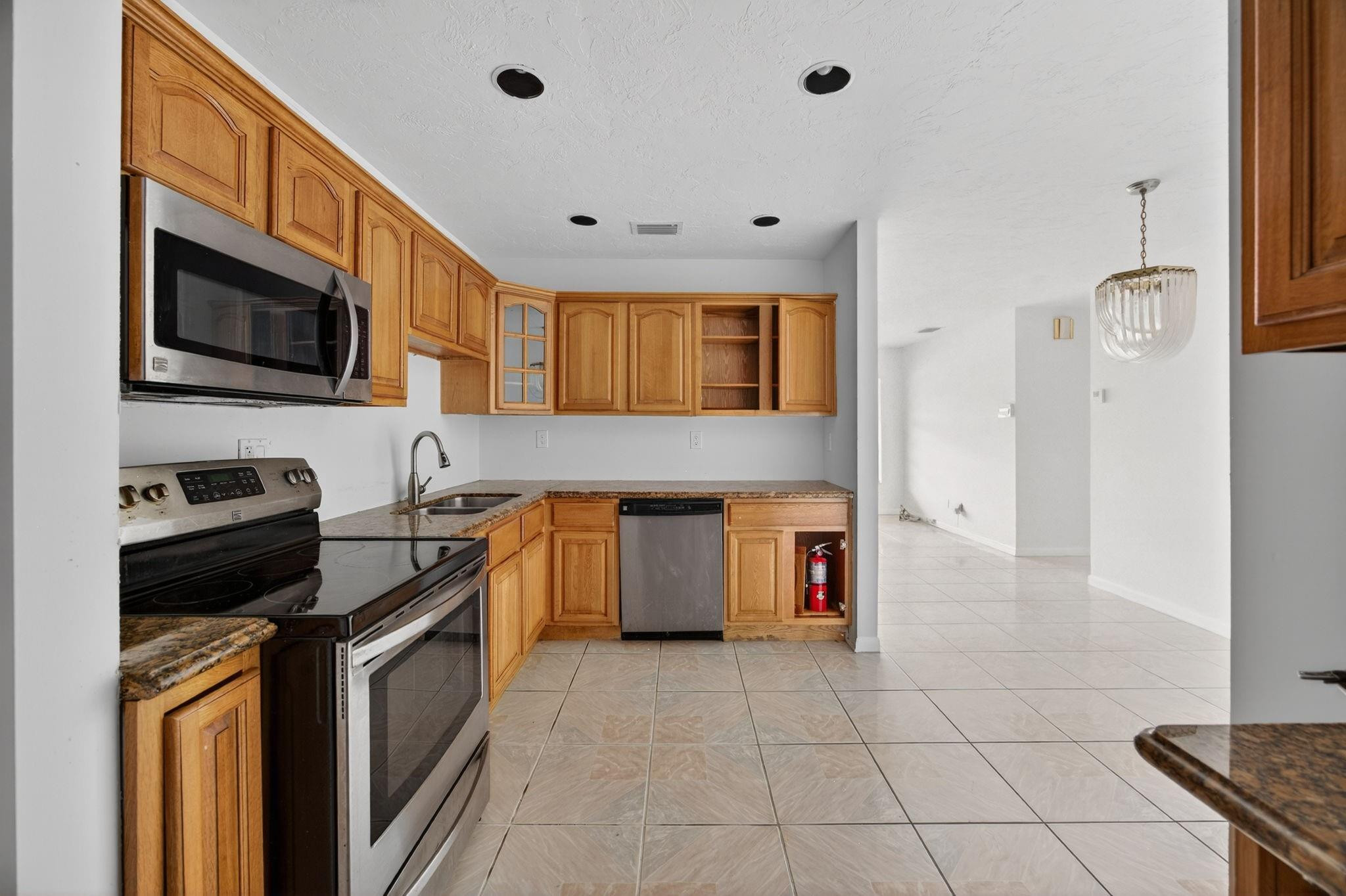 11720 Southwest 176th Street Miami, FL 33177 - Photo 19 of 31 a kitchen with stainless steel appliances granite countertop a stove a sink and a microwave