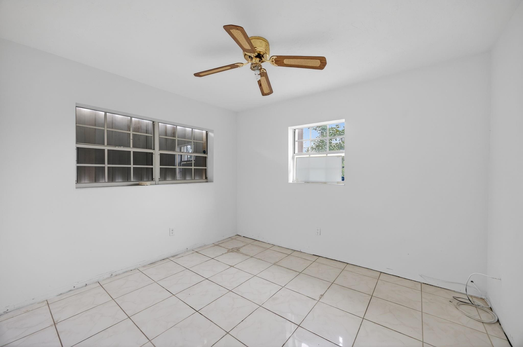 11720 Southwest 176th Street Miami, FL 33177 - Photo 27 of 31 a house view with a ceiling fan and a window