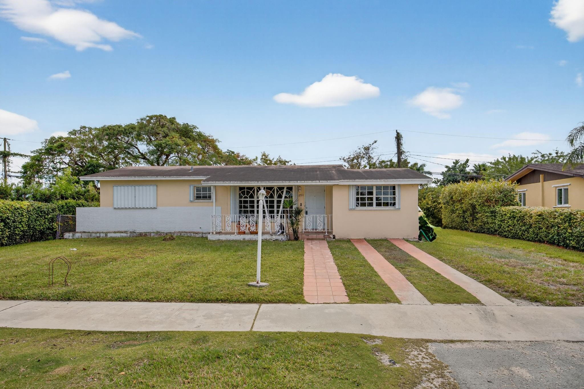 11720 Southwest 176th Street Miami, FL 33177 - Photo 3 of 31 a view of a house with a yard and potted plants