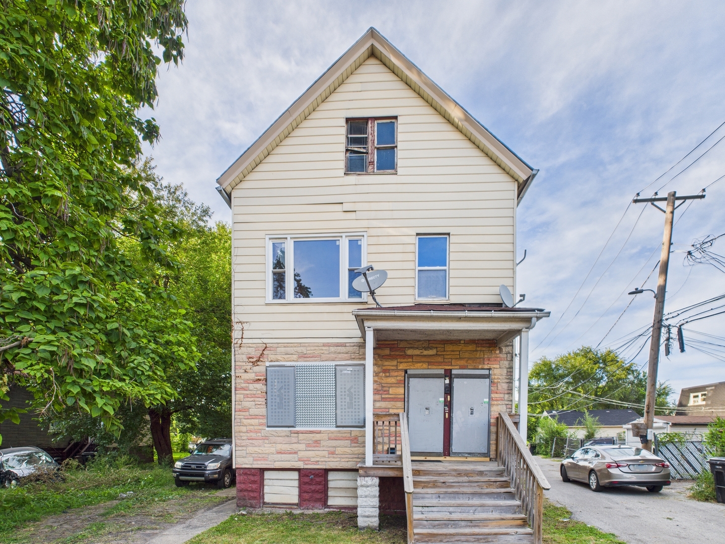 a view of a house with a yard and potted plants