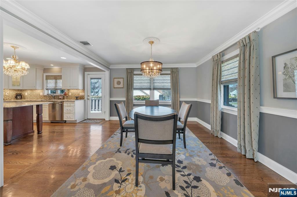 117 Wanamaker Avenue Oradell, NJ 07649 - Photo 12 of 49 a dining room with furniture a chandelier and wooden floor