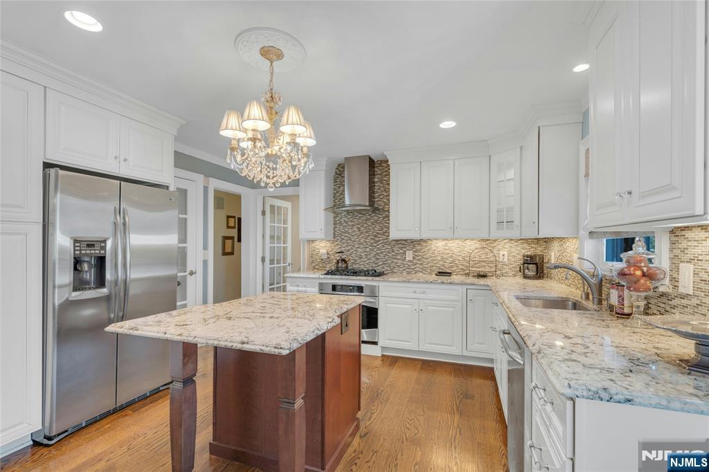117 Wanamaker Avenue Oradell, NJ 07649 - Photo 18 of 49 a kitchen with center island table and chairs