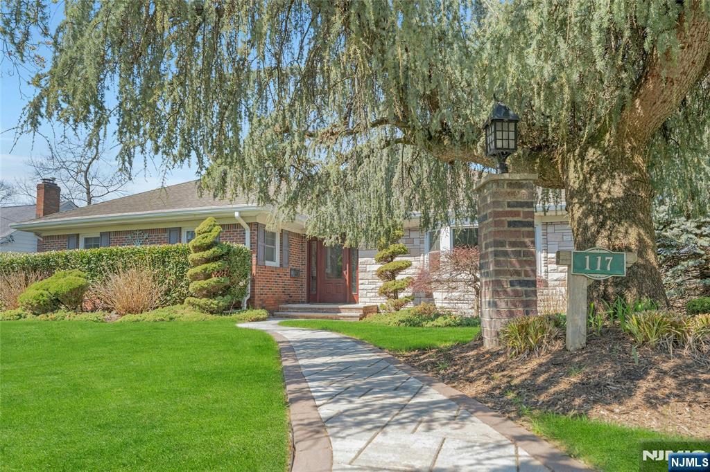 117 Wanamaker Avenue Oradell, NJ 07649 - Photo 2 of 49 a front view of a house with a yard and plants