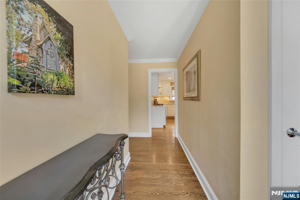 117 Wanamaker Avenue Oradell, NJ 07649 - Photo 23 of 49 a hallway with wooden floor and a bathroom
