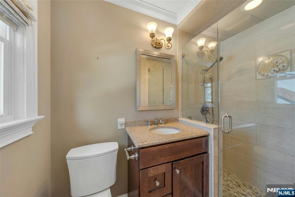 117 Wanamaker Avenue Oradell, NJ 07649 - Photo 28 of 49 a bathroom with a sink a toilet and a mirror