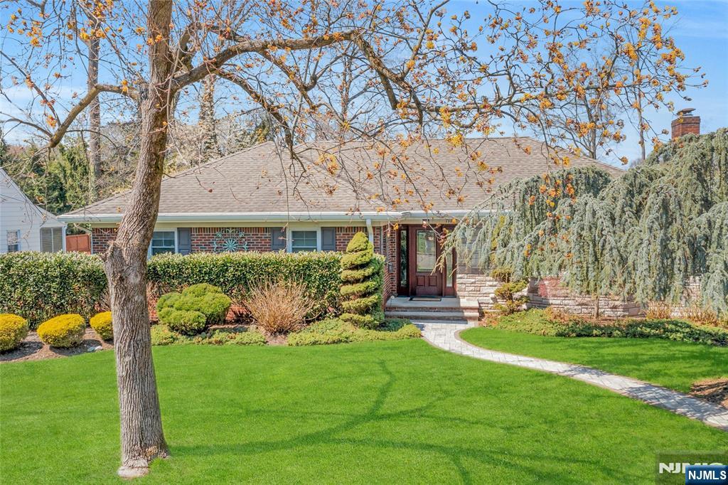 117 Wanamaker Avenue Oradell, NJ 07649 - Photo 3 of 49 a front view of a house with garden and trees