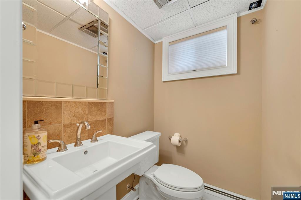 117 Wanamaker Avenue Oradell, NJ 07649 - Photo 39 of 49 a bathroom with a sink mirror vanity and toilet