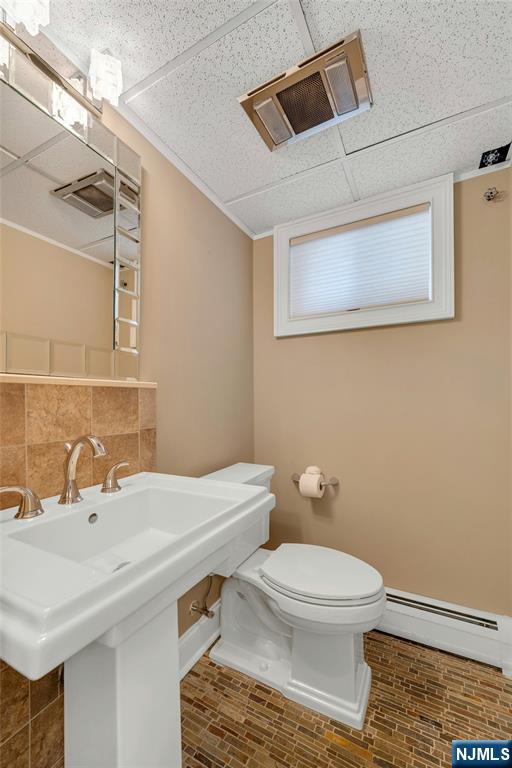 117 Wanamaker Avenue Oradell, NJ 07649 - Photo 40 of 49 a bathroom with a toilet a sink and mirror