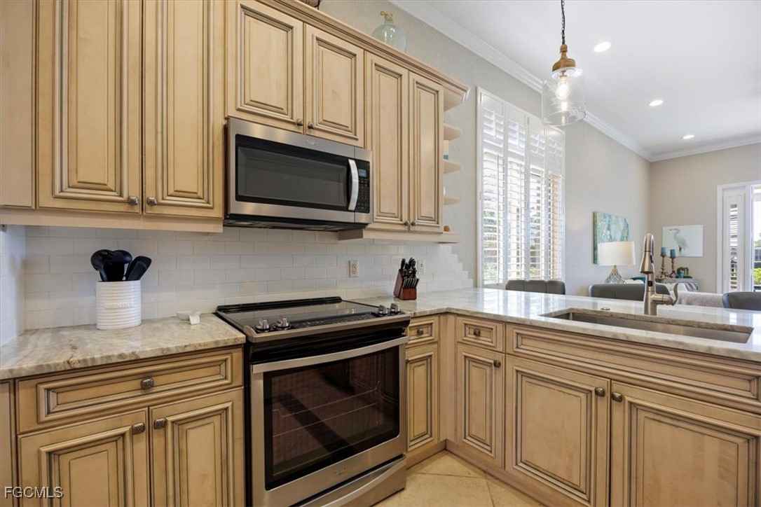 9159 Spring Mountain Way Fort Myers, FL 33908 - Photo 12 of 48 a kitchen with stainless steel appliances granite countertop white cabinets a sink and dishwasher