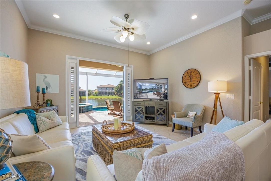 9159 Spring Mountain Way Fort Myers, FL 33908 - Photo 15 of 48 a living room with furniture and a large window
