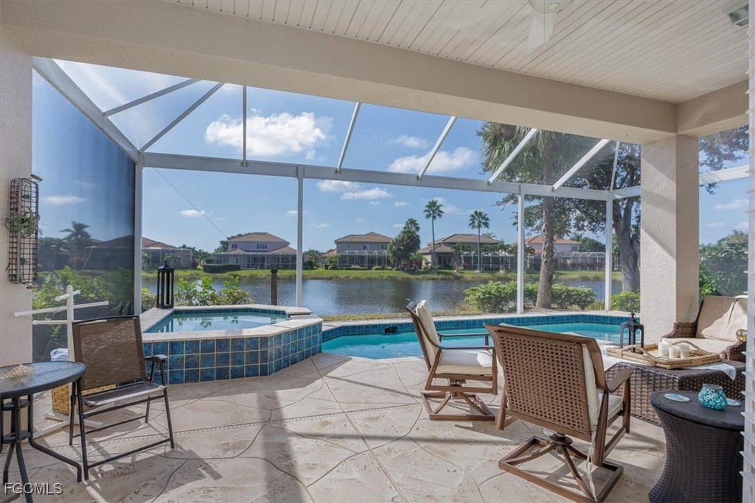 9159 Spring Mountain Way Fort Myers, FL 33908 - Photo 19 of 48 a living room with furniture a floor to ceiling window and kitchen view
