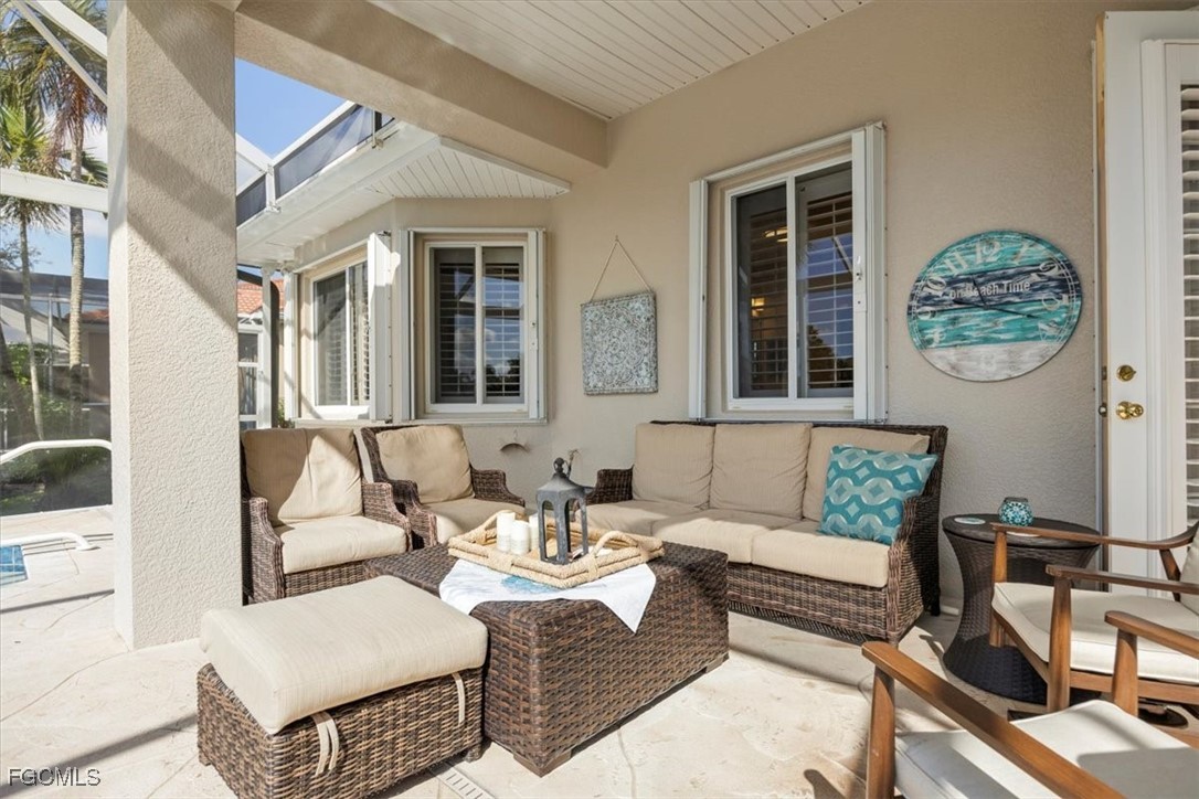 9159 Spring Mountain Way Fort Myers, FL 33908 - Photo 24 of 48 a outdoor living space with furniture and a window