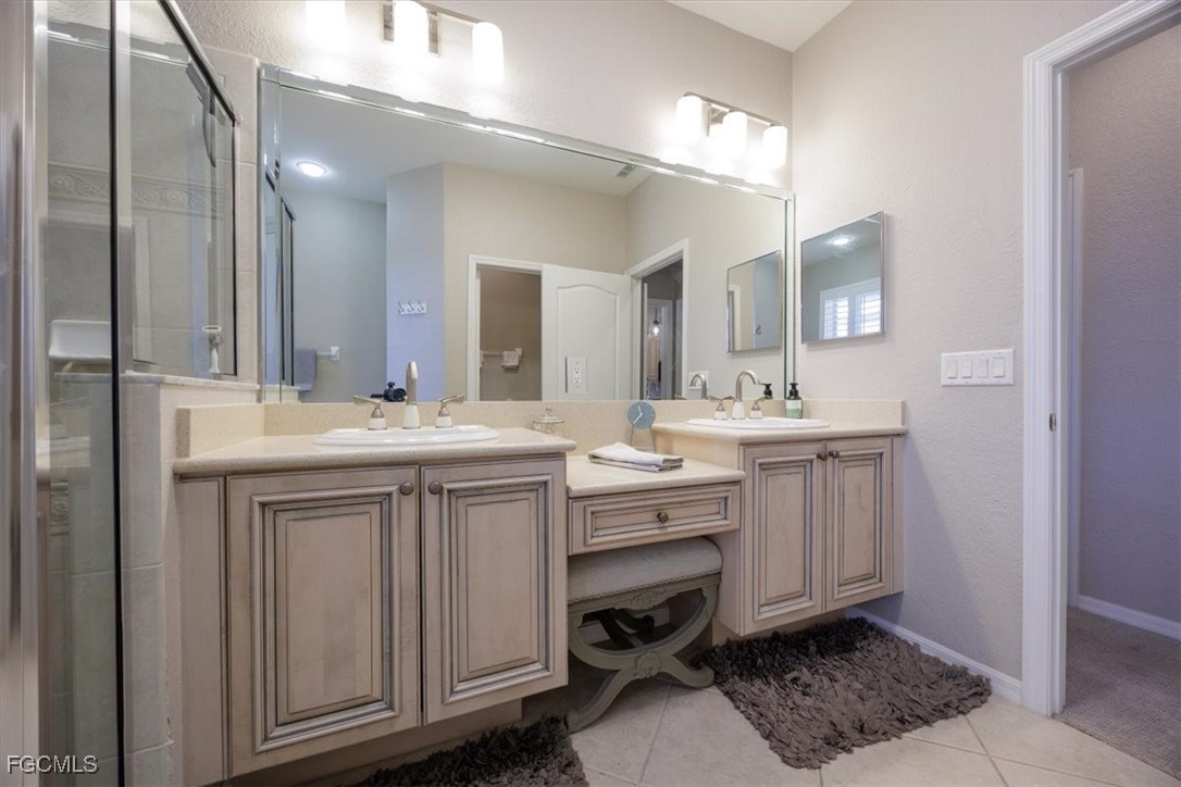9159 Spring Mountain Way Fort Myers, FL 33908 - Photo 31 of 48 a bathroom with a sink vanity and mirror