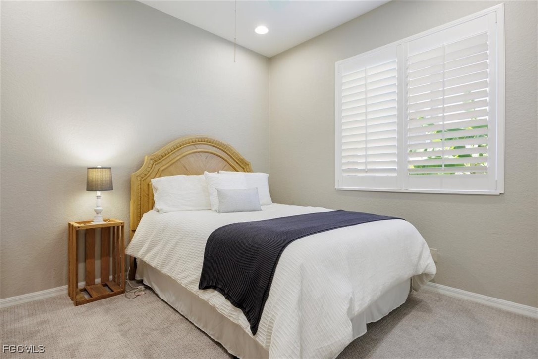9159 Spring Mountain Way Fort Myers, FL 33908 - Photo 36 of 48 a bedroom with a bed and a window