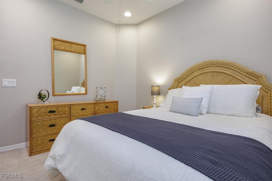 9159 Spring Mountain Way Fort Myers, FL 33908 - Photo 37 of 48 a bedroom with a bed and a dresser