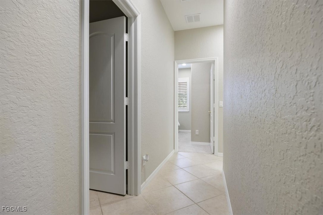 9159 Spring Mountain Way Fort Myers, FL 33908 - Photo 38 of 48 a view of a hallway to rooms