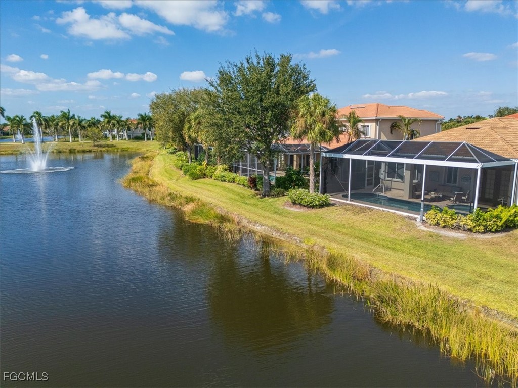 9159 Spring Mountain Way Fort Myers, FL 33908 - Photo 40 of 48 a view of a lake with a house in the background