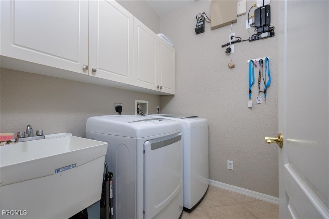 9159 Spring Mountain Way Fort Myers, FL 33908 - Photo 43 of 48 a utility room with dryer and washer