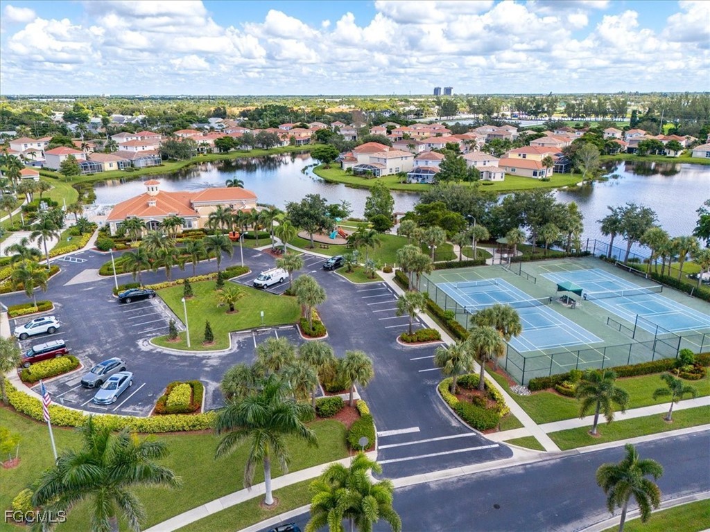 9159 Spring Mountain Way Fort Myers, FL 33908 - Photo 46 of 48 an aerial view of residential houses with outdoor space and parking