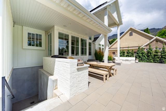 630 East Center Street Alpine, UT 84004 - Photo 66 of 115 Spacious outdoor patio featuring light-toned paver flooring, a covered porch with white columns, and large windows