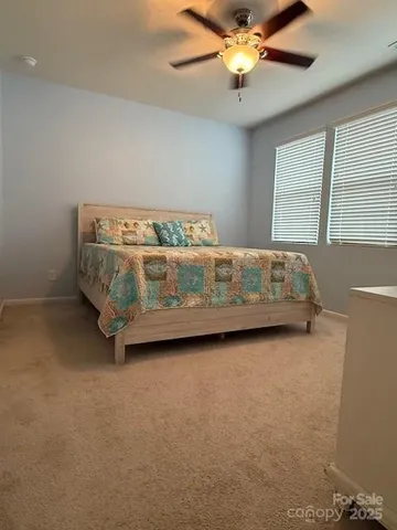 a bed sitting in a room next to a window