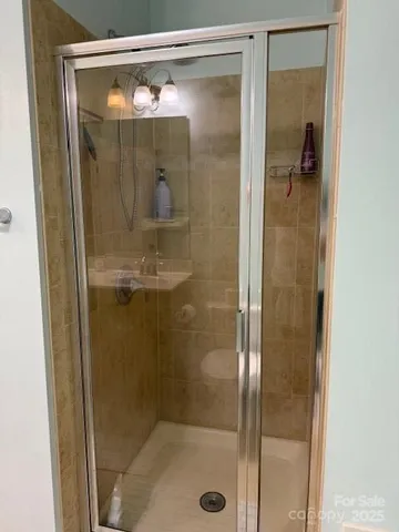 a bathroom with a glass shower door