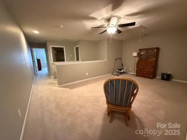 a living room with furniture and a ceiling fan