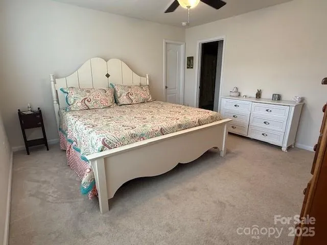 a bed sitting in a bedroom chandelier furniture and a dresser