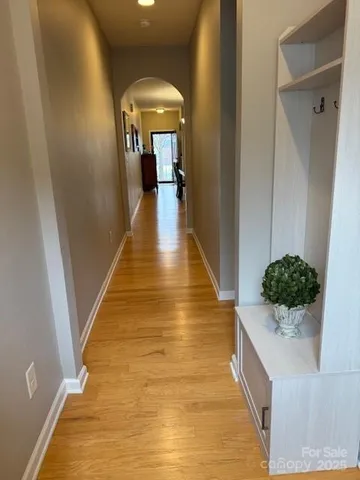 a view of entryway and hall with wooden floor