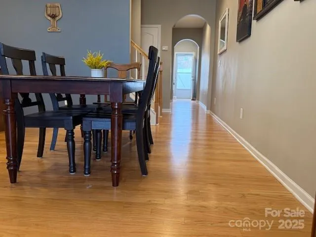 a dining room with furniture and wooden floor