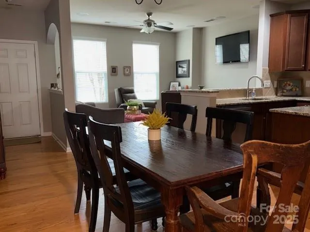 a view of a a dining room with furniture window and wooden floor