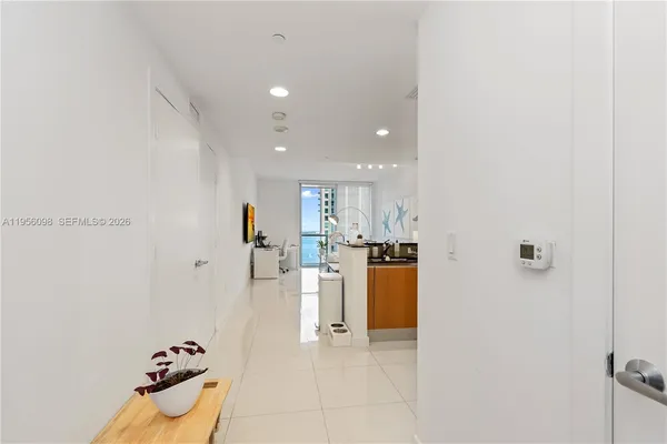 a view of kitchen with furniture and stainless steel appliances