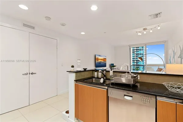 a kitchen with a sink and a refrigerator