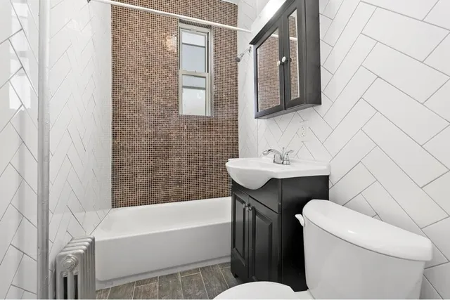 a bathroom with a sink a toilet and bathtub