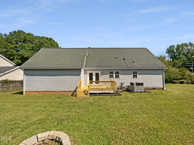a backyard of a house with table and chairs