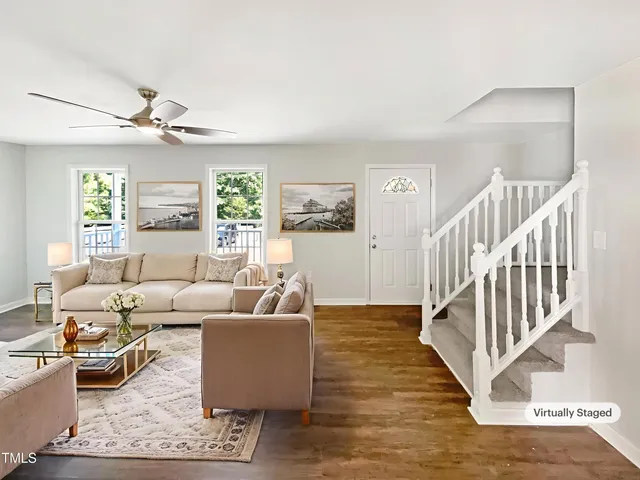 a living room with furniture and wooden floor