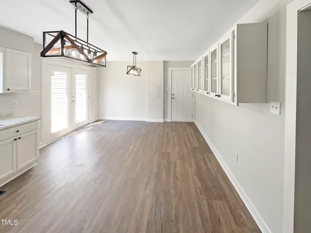 a view of a livingroom with wooden floor and staircase