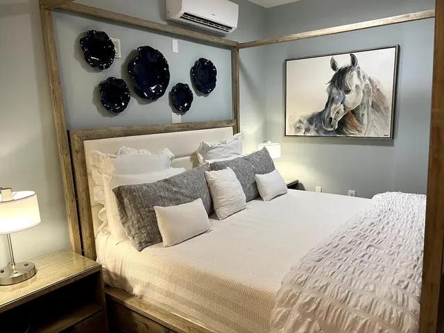 a bedroom with a bed and wall painting