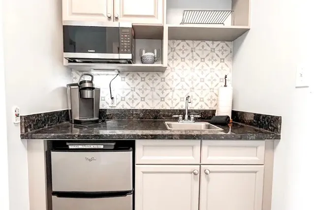 a kitchen with stainless steel appliances granite countertop a sink stove and microwave