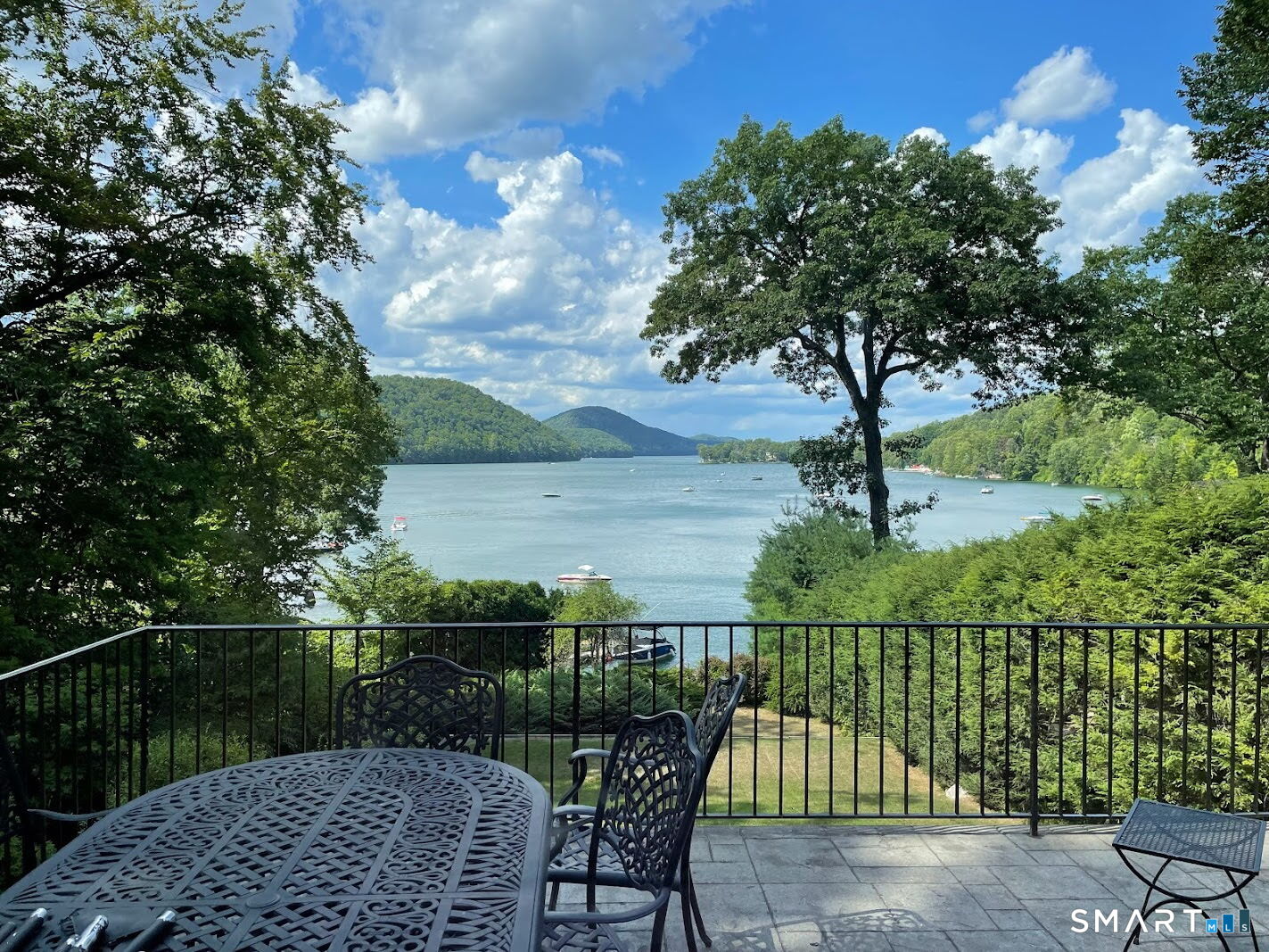 892 Candlewood Lake Road South New Milford, CT 06776 - Photo 1 of 1 a view of a roof deck with chair and wooden fence